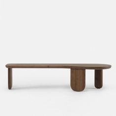 a wooden bench sitting on top of a white floor