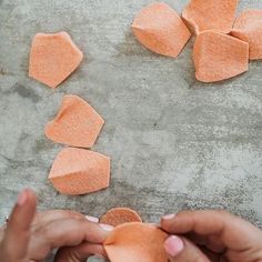 someone is making something out of clay on the cement floor with their hands and fingers