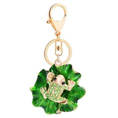 a keychain with a green leaf and an elephant in the center on a white background