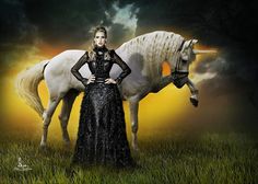 a woman standing next to a white horse on top of a lush green field under a cloudy sky