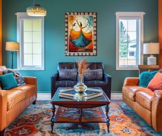 a living room with two couches, a coffee table and paintings on the wall