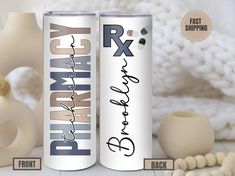 two personalized aluminum cans with names on them next to some beads and vases