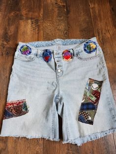 "This is a unique one of a kind Jean/denim shorts. Old Navy,  size 18 with some extra stretch.  These shorts are emblished with a beautiful selection of fabric and securely joined to the shorts for much ware and tear. I RECOMMEND gentle washings but that's just me. Let me know if you have questions. Size: 18 waist: 38\" waist to shorts hems: 18\" inseem: 8\"" Festival Denim Jean Shorts, Bohemian Denim Shorts For Festivals, Bohemian Denim Cutoff Jean Shorts, Bohemian Cutoff Denim Jean Shorts, Cutoff Denim Shorts With Patches, Bohemian Denim Jean Shorts, Patchwork Denim Jean Shorts, Cotton Jean Shorts With Patches, Denim Shorts With Patches In Short Length