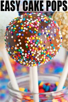 cake pops with sprinkles on them in a clear glass bowl and text overlay that reads easy cake pops