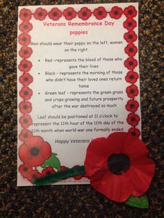 a remembrance card with a red flower and poem written in the bottom right hand corner