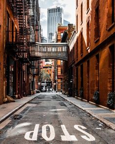 an empty street with the word slow painted on it in front of some tall buildings