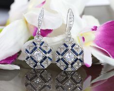 Vintage Art Deco Earrings, Drop Dangle Diamond Earrings, Round & Sapphire Diamond Antique Edwardian 14K White Gold Over Earrings 1920's Item Description: Main Stone Shape: Round Cut Stone: Cubic Lab Created Metal Customization: 1. White Gold: 10K/14K/18K 2. Yellow Gold: 10K/14K/18K 3. Rose Gold: 10K/14K/18K 4. Silver: Sterling Silver 925 Main Stone: Cubic Zirconia, Moissanite, Natural Diamond, CVD Diamond * Check out Special Notes: At checkout, leave us a note in the message box for the Ring Art Deco Sapphire Earrings, White Gold Art Deco Wedding Earrings, Art Deco White Gold Wedding Earrings, Art Deco Diamond Cut Earrings For Wedding, Art Deco Diamond Cut Wedding Earrings, Blue Art Deco Wedding Earrings, Art Deco Round Earrings For Wedding, Art Deco Drop Earrings For Anniversary, Art Deco Round Wedding Earrings