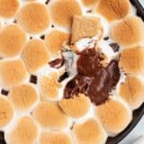 a pan filled with marshmallows and chocolate sauce