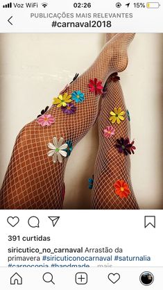 a woman wearing fishnet stockings with colorful flowers on them