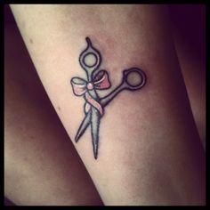 a tattoo on the leg of a woman with scissors and ribbon around her neck,