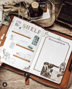 an open planner book sitting on top of a wooden table next to a pen and other items