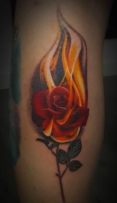 a red rose with flames on the side of her thigh and arm, is shown