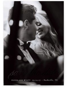 a black and white photo of a man and woman in formal wear kissing each other