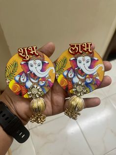 the pair of earrings is decorated with an elephant