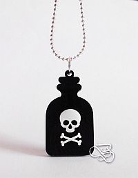 a bottle with a skull and crossbones on it is hanging from a chain