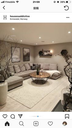 a living room filled with lots of furniture next to a white rug on top of a hard wood floor