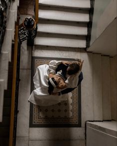 an overhead view of a bride and groom on the stairs