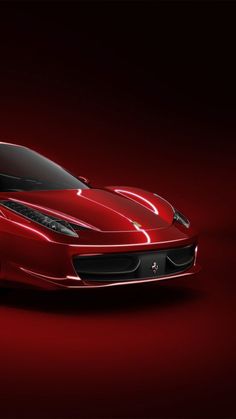 a red sports car is shown on a dark background in this image, it appears to be from the side view