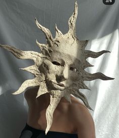 a woman wearing a sun mask with her face cut out to look like a human head