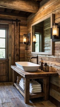 a rustic bathroom with wood walls and wooden flooring has a large white bowl sink