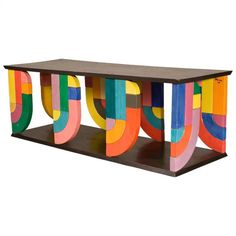 a multicolored wooden shelf with letters painted on it