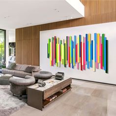 a living room filled with furniture and colorful paintings