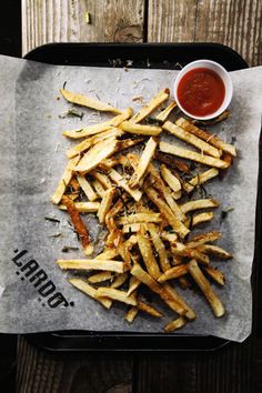 french fries with ketchup are on a tray