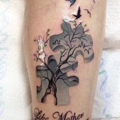 a person with a puzzle piece tattoo on their leg that says like mother and child