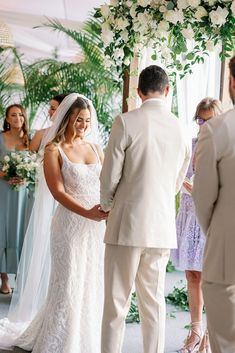 a bride and groom standing at the alter during their wedding ceremony