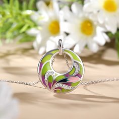 Add a pop of color to your look with the flower enamel necklace. An unusual silver necklace finished with a pendant of mixed coloured enamel circle set in a flower design. A tonal combination of colours make this a very versatile necklace to wear with lots of different outfits.Carat Weight: 0.225 ctStone Size: 1,1.2 mmNumber of Stones: 17 Stone Shape: RoundStone Color: Diamond WhiteWeight: 4.93 gWidth: 25 mmHeight: 28.8 mmThickness: 5.3 mmMaterial: 925 SilverStone Type: Jeulia® StonePlating Colo Green Necklace With Flower Charm And Round Pendant, Enamel Round Pendant Necklace, Multicolor Enamel Round Pendant Necklace, White Gold Enamel Round Pendant Necklace, Green Enamel Pendant Necklace, Green Enamel Round Pendant Jewelry, Dreamy Garden, Enamel Necklaces, White Necklace