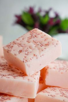 several pieces of pink and white soap stacked on top of each other with sprinkles