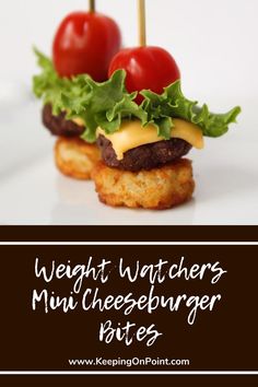 two mini cheeseburger bites with tomatoes and lettuce on them, sitting next to each other