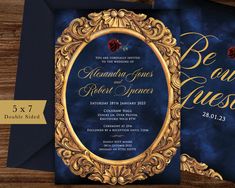 an ornate frame with roses on it is displayed in front of a blue and gold wedding card