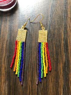 These rainbow and gold square stitch dangle earrings are extremely lightweight and will spice up any outfit. These earrings were inspired by my art teaching career (ROYGBIV) and my daughter's love of all things that have rainbows and unicorns. These are locally made in Kansas City and 100% hand-beaded. Get ready to chase your rainbows!! 100th Day Of School Crafts, Stitch Beads, Rain Earrings, Rainbows And Unicorns, Square Stitch, Art Teaching, Teaching Career, Handmade Earrings Beaded, Brick Stitch