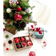 a christmas tree decorated with red and white baubles, ornaments and other decorations