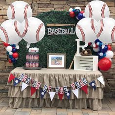 a table topped with balloons and baseballs