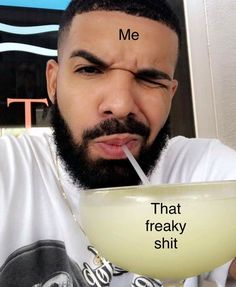 a man drinking from a bowl with a straw in his mouth