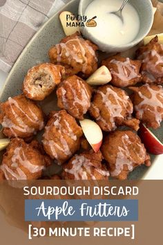 a plate full of apple fritters on a table with dipping sauce in the background