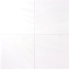 a white wall with four squares in it