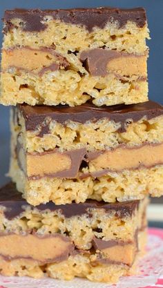 three pieces of chocolate peanut butter bars stacked on top of each other