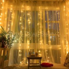 a living room filled with lots of lights next to a window covered in sheer curtains