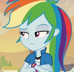 a pony with rainbow hair standing in front of a sunset and looking at the camera