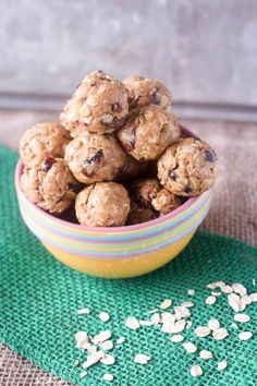 a bowl filled with oatmeal and raisins on top of a green place mat