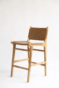 a wooden chair sitting on top of a white floor