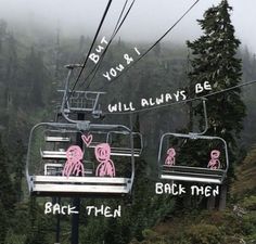 two ski lifts with pink cartoon figures on them in front of some trees and mountains