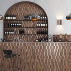 an empty bar with stools and bottles on the wall behind it in a restaurant