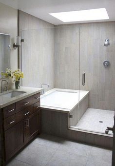 a bathroom with a tub, sink and shower stall is pictured in this image from the front view