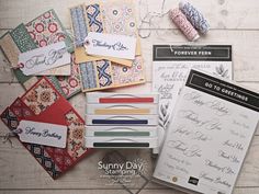 many different types of greeting cards are laid out on a table with scissors and thread