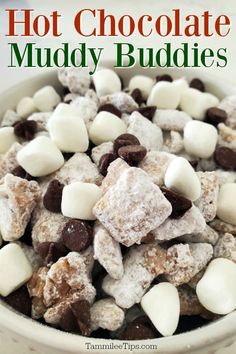 hot chocolate muddy buddies in a white bowl with marshmallows and chocolate chips