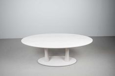 a white round table with two legs on the top and one leg in the middle